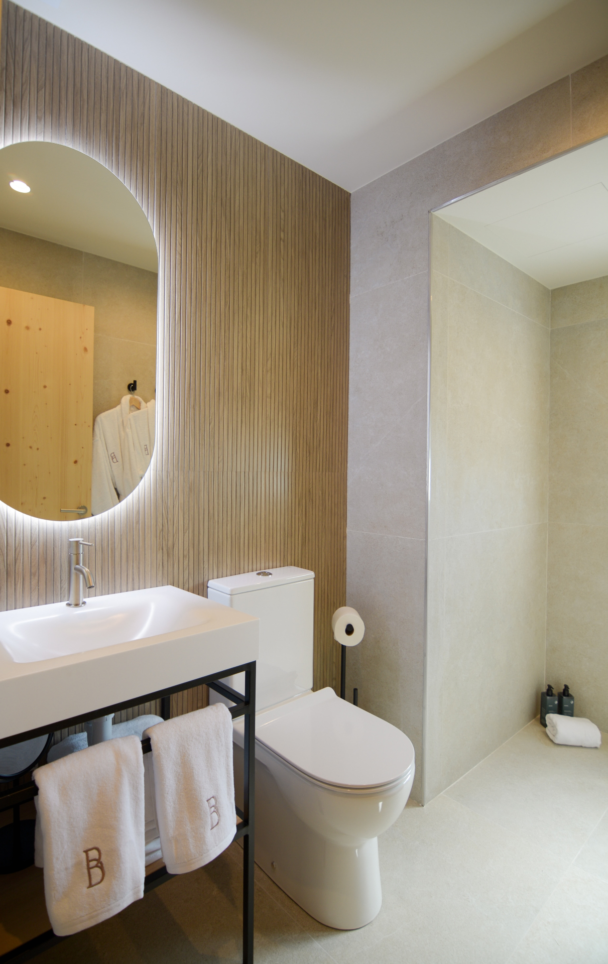 Superior Suite en-suite bathroom with oval backlit mirror and walk-in shower
