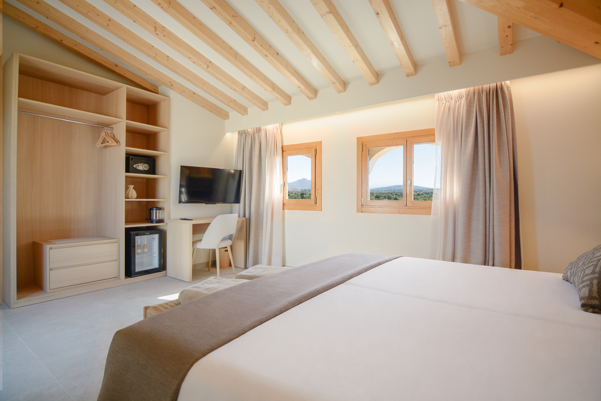 Superior Suite interior with wardrobe, workspace and countryside windows